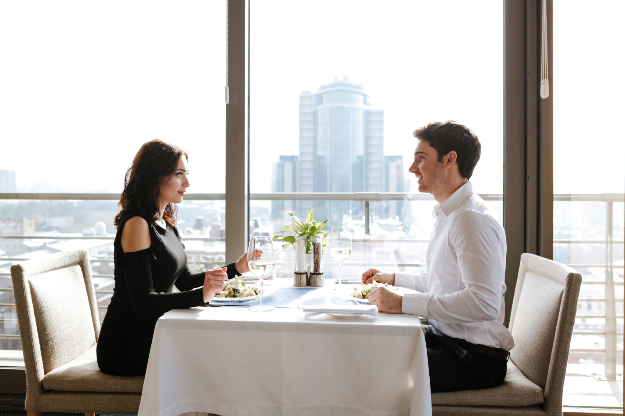 Loving couple sitting in restaurant indoors モテコンサルティング